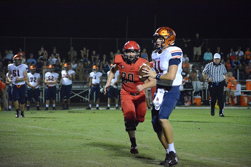 Cardinal Mooney senior defensive lineman Doug Polk chases down the Lemon Bay quarterback.