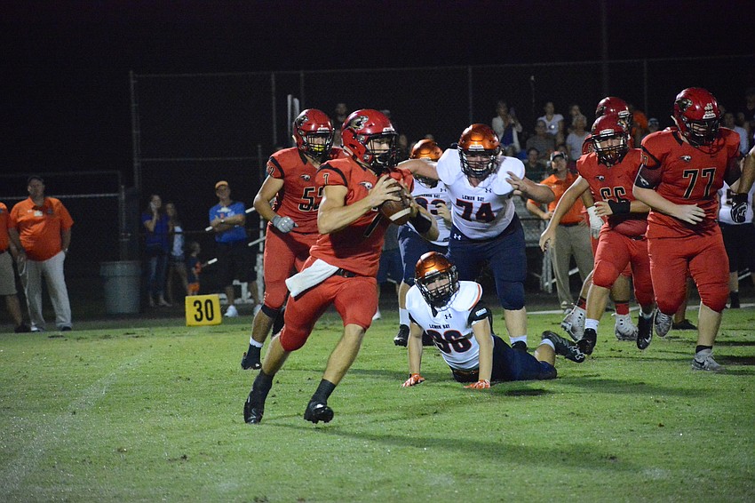 Cardinal Mooney senior quarterback Jack Koscho rolls to his right.