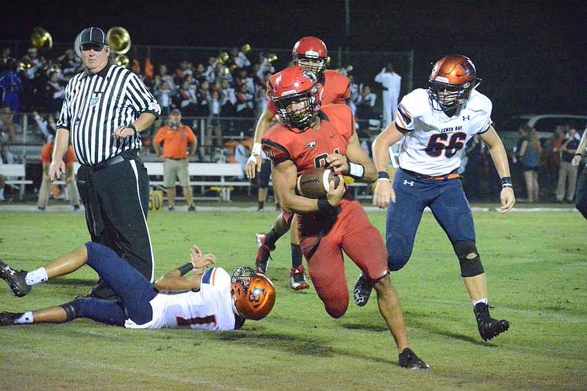 Cardinal Mooney senior running back Bryce Williams breaks through the Lemon Bay defense.