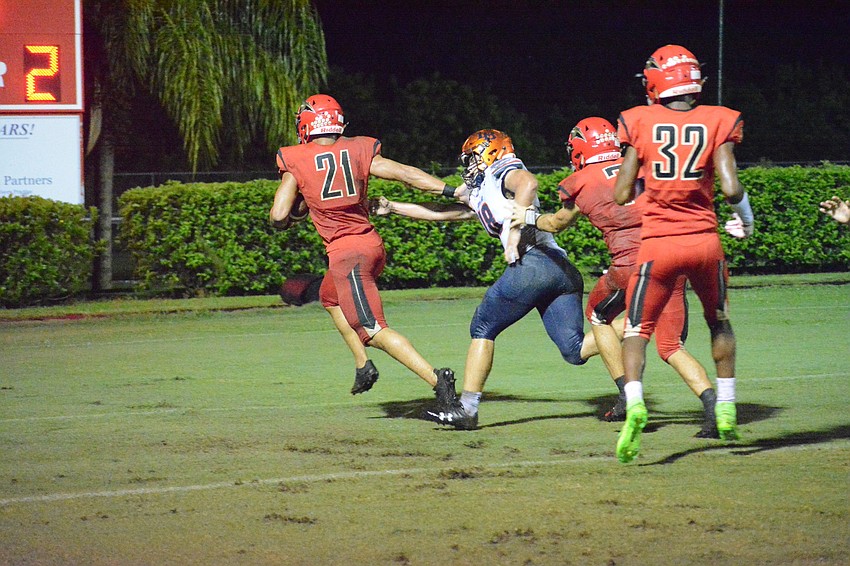 Cardinal Mooney senior running back Bryce Williams stiff arms a defender before crossing the goal line.