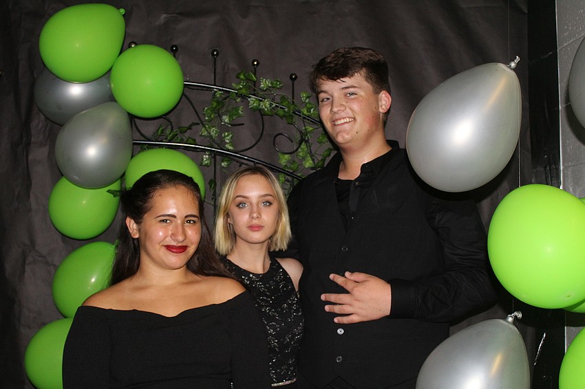 Lakewood Ranch High School sophomore Hailey Bagshaw, senior Hailey Sevier and senior Rylan Buck explore the decor at the homecoming dance.