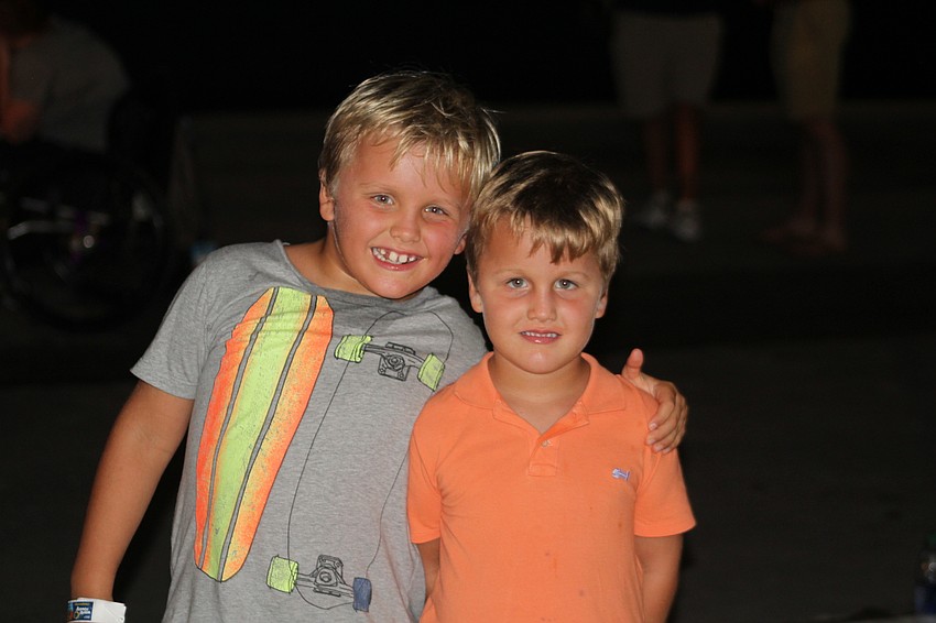 Sarasota's Austin and Tanner Bobb hang out in the front row for the opening ceremony.