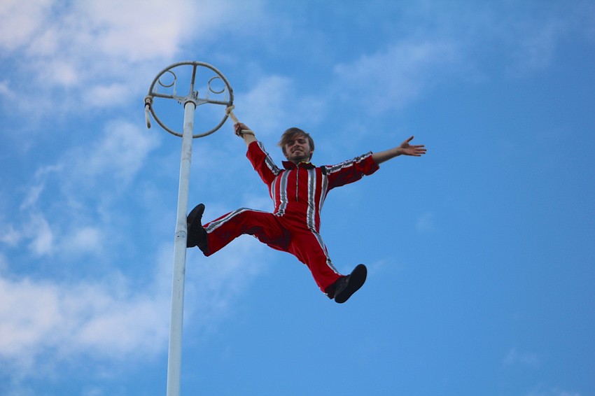 Nock Productions' Andrew Nock sways high in the sky as World Rowing Championship attendees enter the park for the opening ceremony.