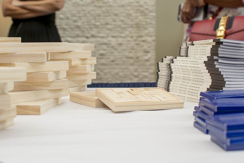 Puzzles and books were displayed on a table as guests arrived at the event.