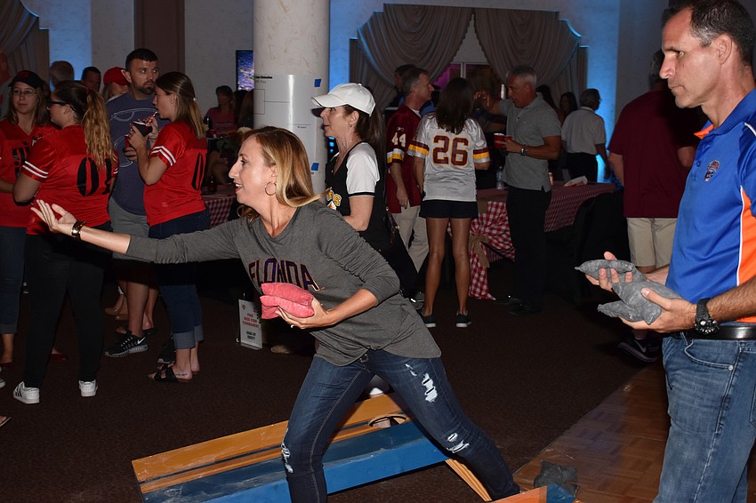 Candice McElyea plays cornhole with her husband Kevin at Totally Tailgate on Sept. 23 at Michael’s On East.