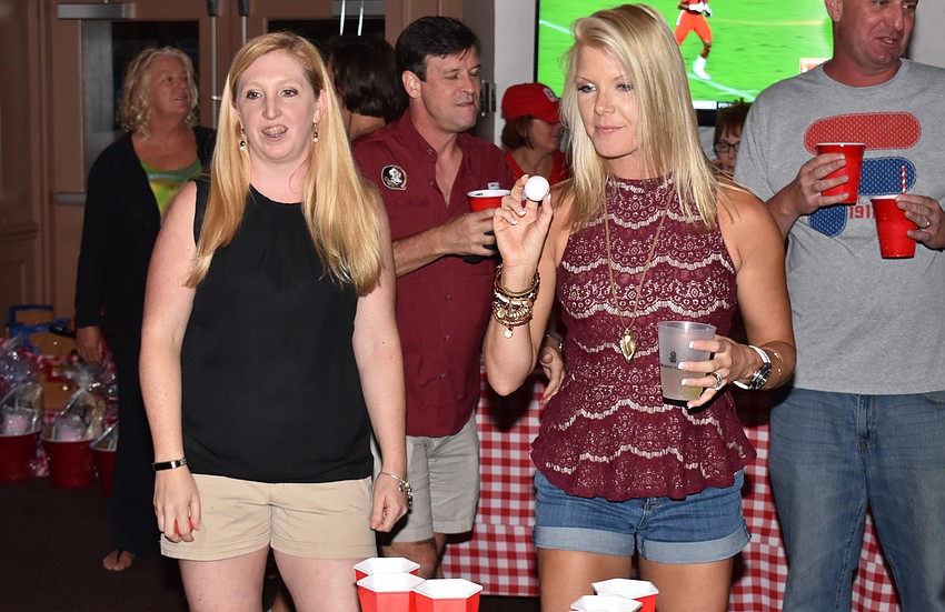 Karen Goldstein and Krystel Beall play beer pong at Totally Tailgate on Sept. 23 at Michael’s On East.