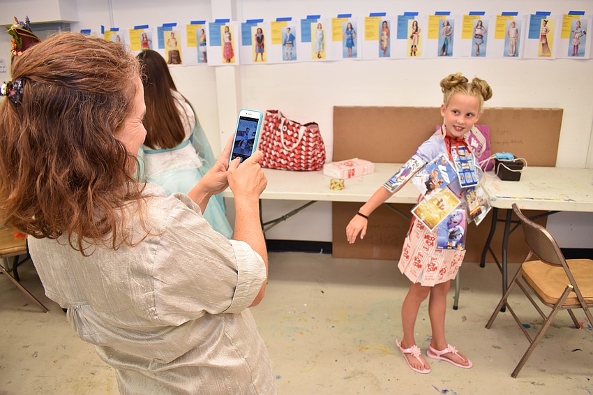 Amy Treibly takes a photo of her daughter Lucy before the iconcept jr. fashion show on Sept. 24 at Art Center Sarasota.