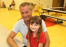 Scott Toedman and Braden River Elementary School kindergartener Olivia Matthews sit down to enjoy breakfast.