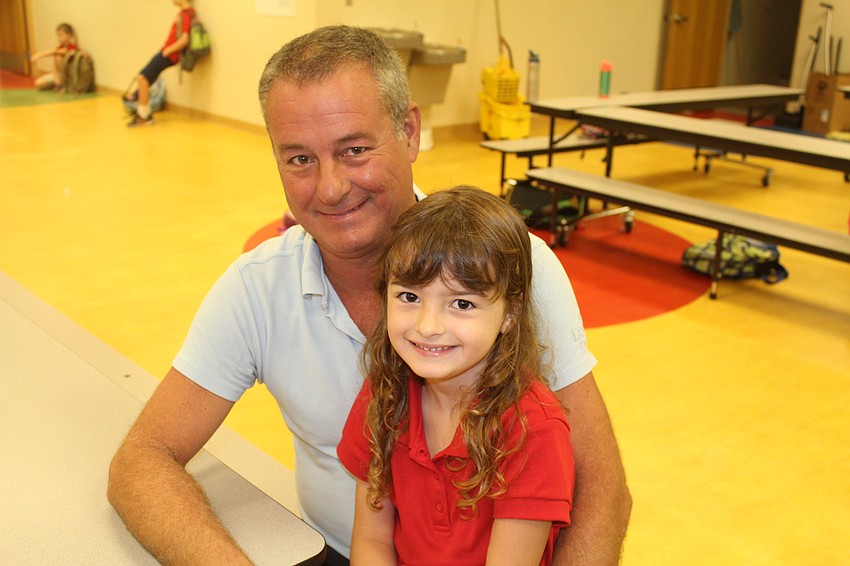 Scott Toedman and Braden River Elementary School kindergartener Olivia Matthews sit down to enjoy breakfast.
