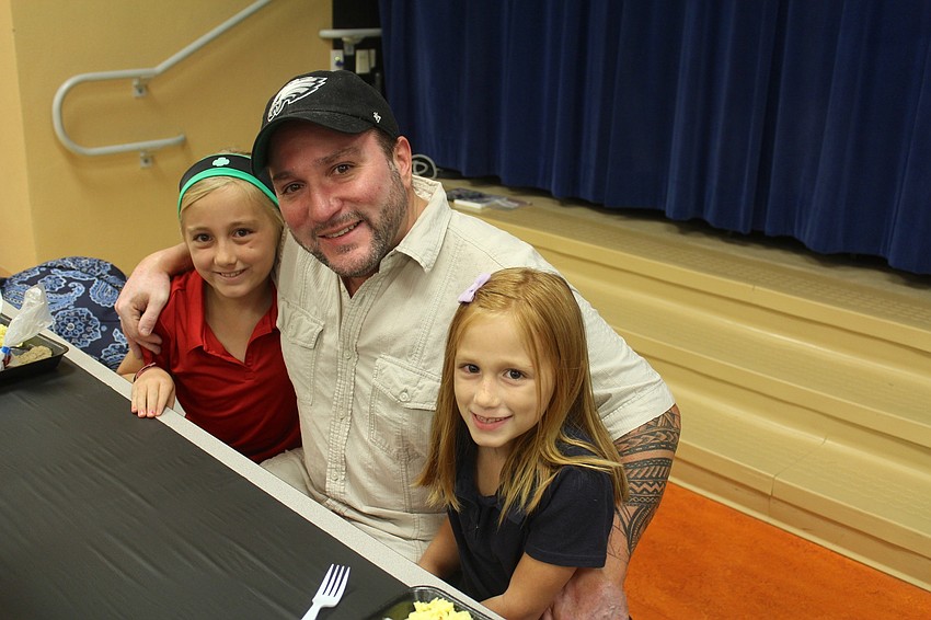 Braden River Elementary School fifth-grader Abby Burns, Jeff Burns and second-grader Emma Burns eat breakfast with dad.