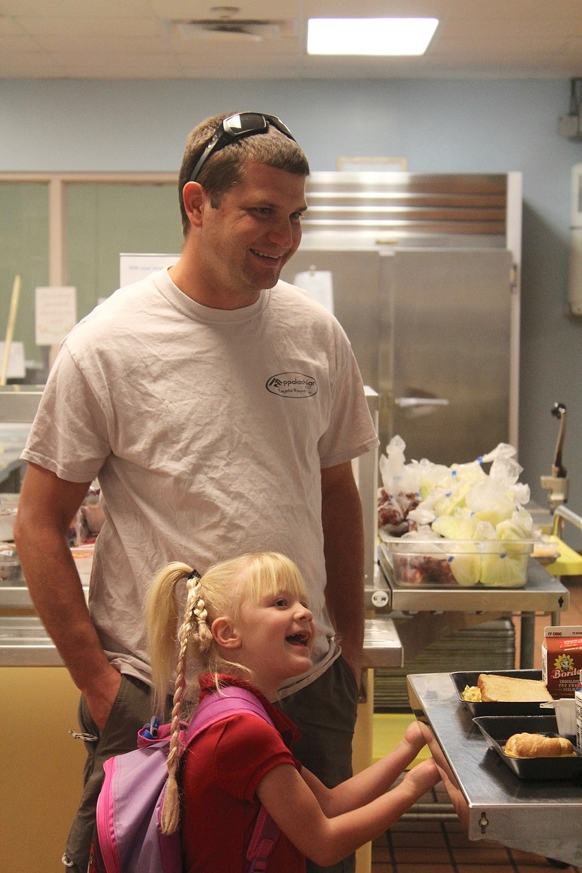 Christopher and Ava Brooks get breakfast together in the cafeteria at Braden River Elementary School.
