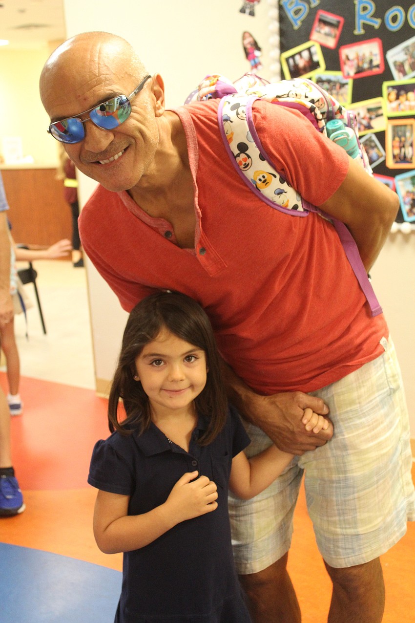 Braden River Elementary School kindergartener Simona Mazzucco waits in line with her dad, Mariol Mazzucco, for breakfast.