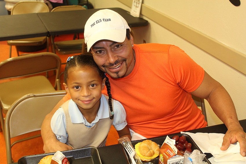 Braden River Elementary School second-grader Aija Gonzalez and her dad, Angel Gonzalez, enjoy egg and cheese croissants.