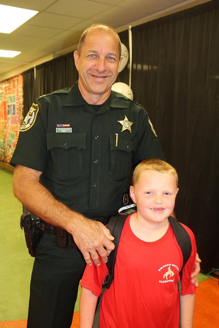 Stan Schaeffer and Braden River Elementary School kindergartener Mitchell Schaeffer wait in line for breakfast.