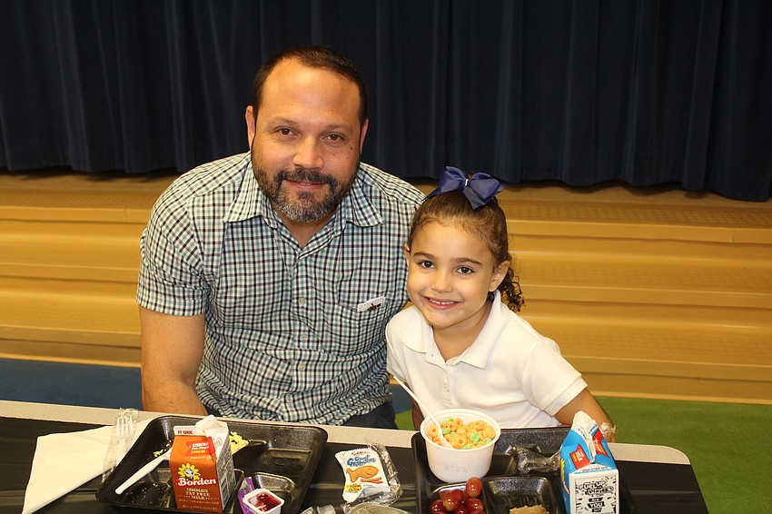 Axel Nunez and Braden River Elementary School kindergartener Giuliana Nunez eat some cereal together in the VIP lounge.