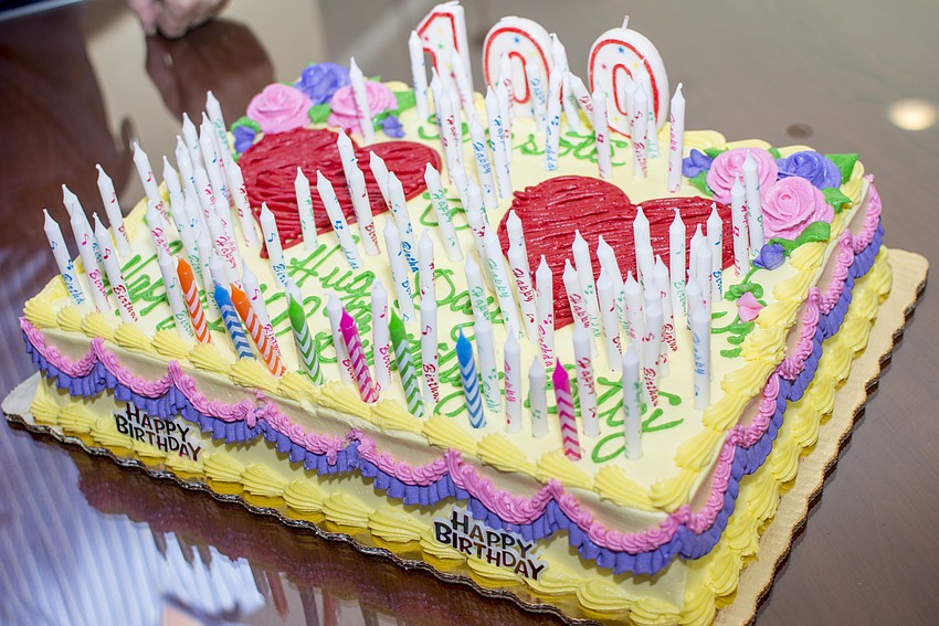 One hundred candles decorated a cake celebrating Heart to Heart Hug Day.