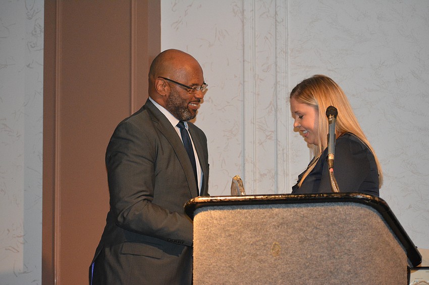 Tim Johnson accepts his award from Jeana Schmidt.