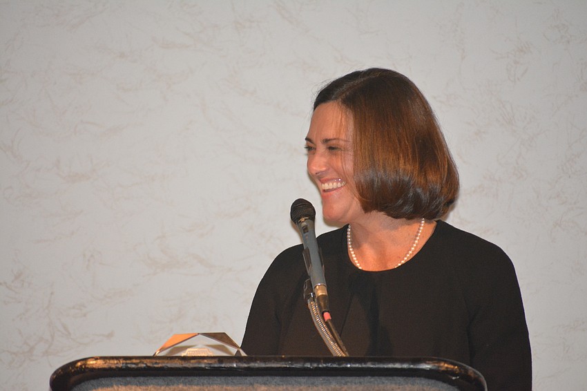 Page Dunlap Halpin laughs during her speech.