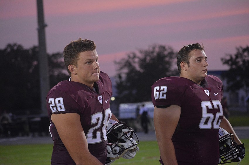 Sophomore tight end Travis Tobey and senior guard Luke Andrews stand for the coin toss.