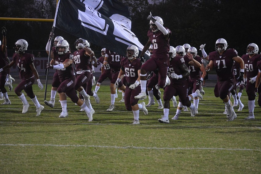 The Pirates charge onto the field.