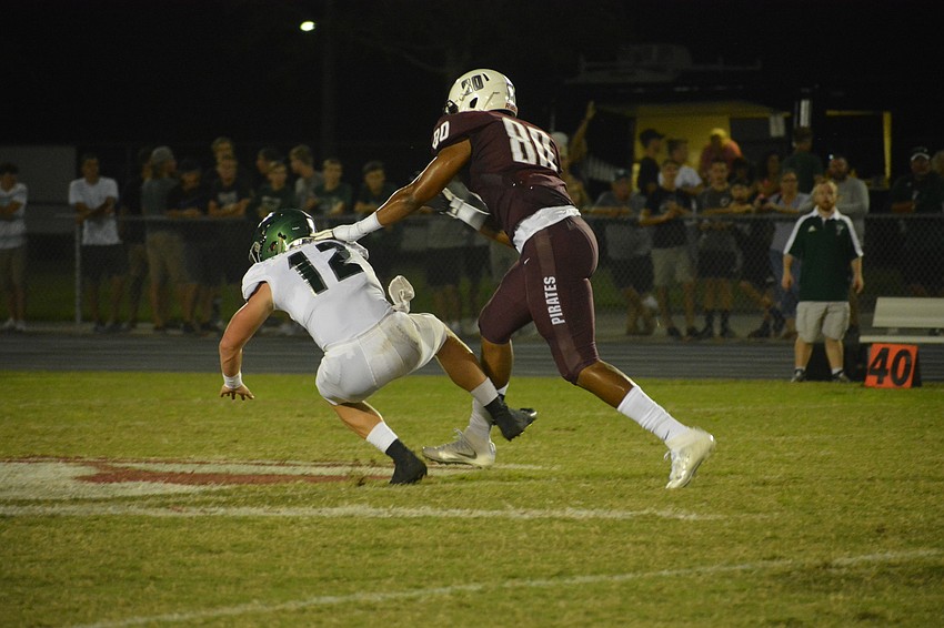 Venice senior quarterback Bryce Carpenter is pounded by Braden River senior defensive lineman Taylor Upshaw.