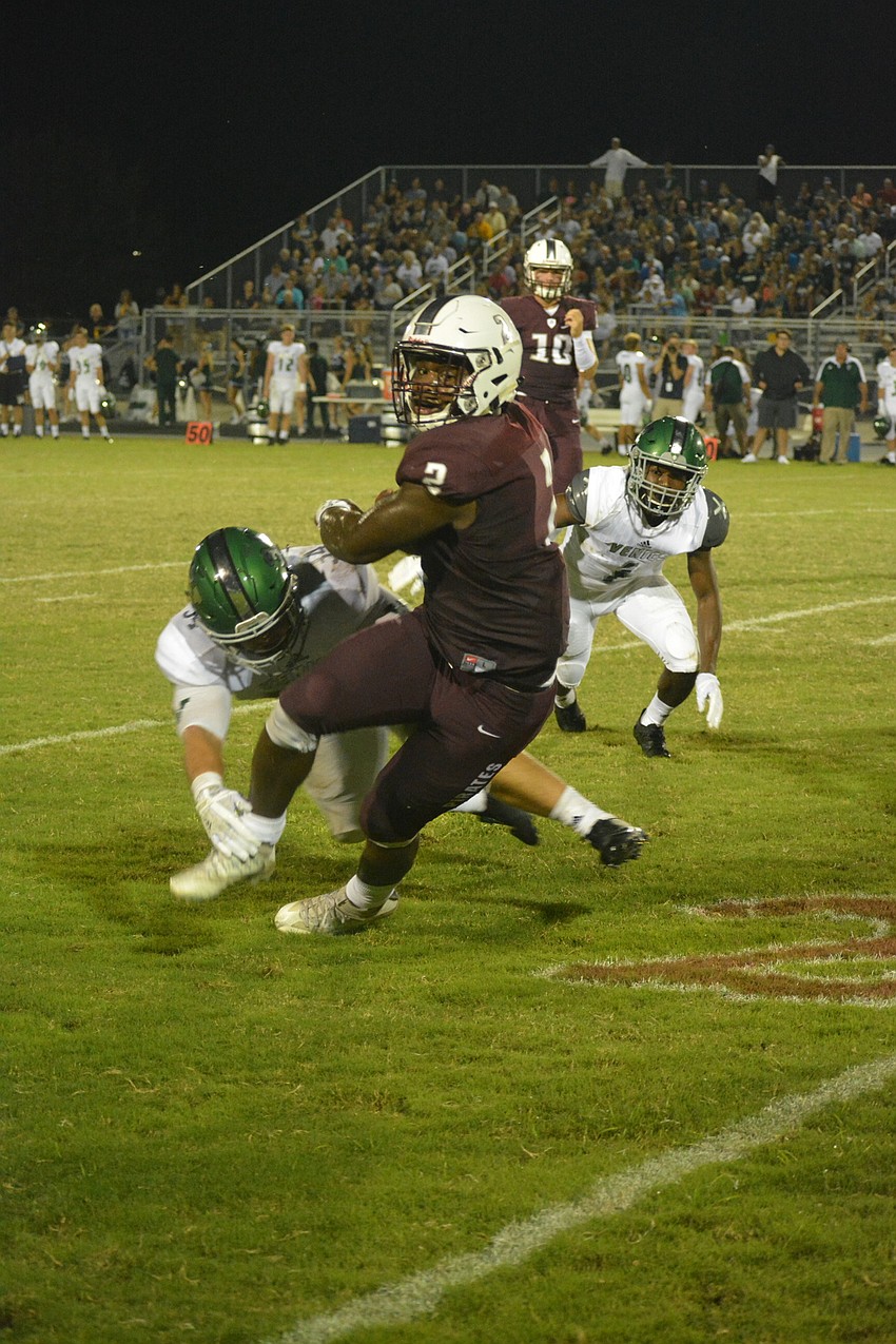 Senior running back Deshaun Fenwick spins out of a tackle.