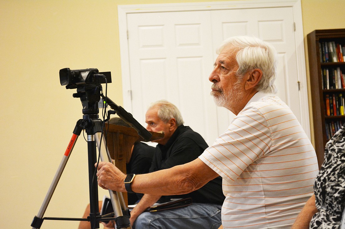 GreyHawk Landing resident Tony Bryan uses his personal video equipment to record community development district meetings.