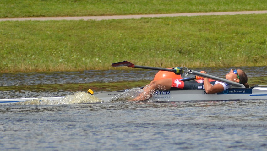 Switzerland's Patricia Merz collapses after finishing fourth in the Lightweight Women's Single Sculls final on Friday in Sarasota.