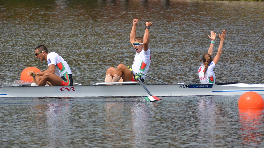 Hungary's Bela Simon Jr., Adrian Juhasz and Andrea Vanda Kollath react after winning the Men's Coxed Pair competition. Kollath is the coxswain.