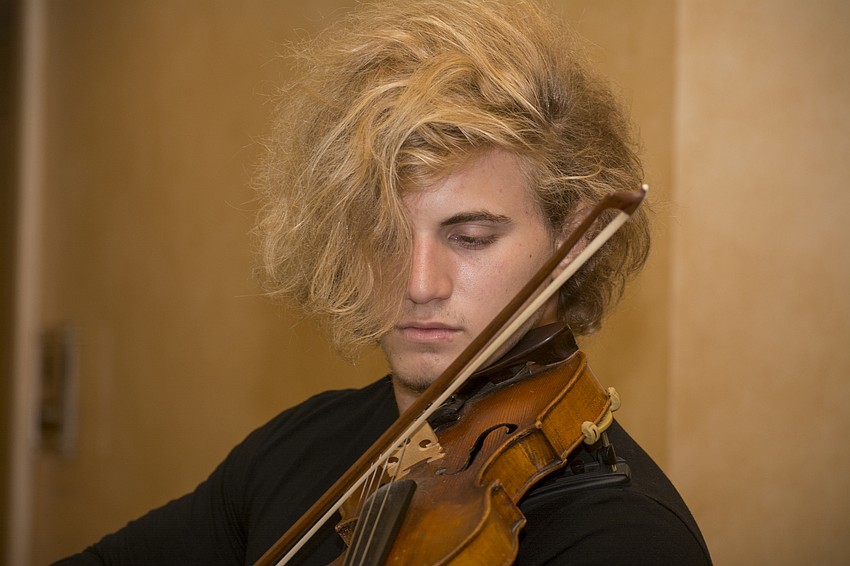 Paul Leonov plays the violin for patrons on the second floor of the Sarasota Opera House during the fourth annual Taste of Downtown event.