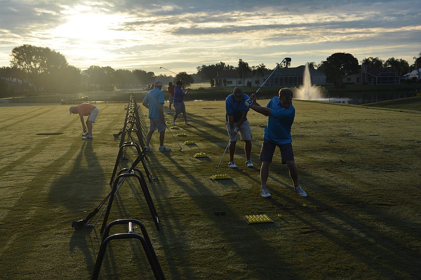 Golfers prepare for the Elks Golf Tournament just after dawn at Tara Golf & Country Club.