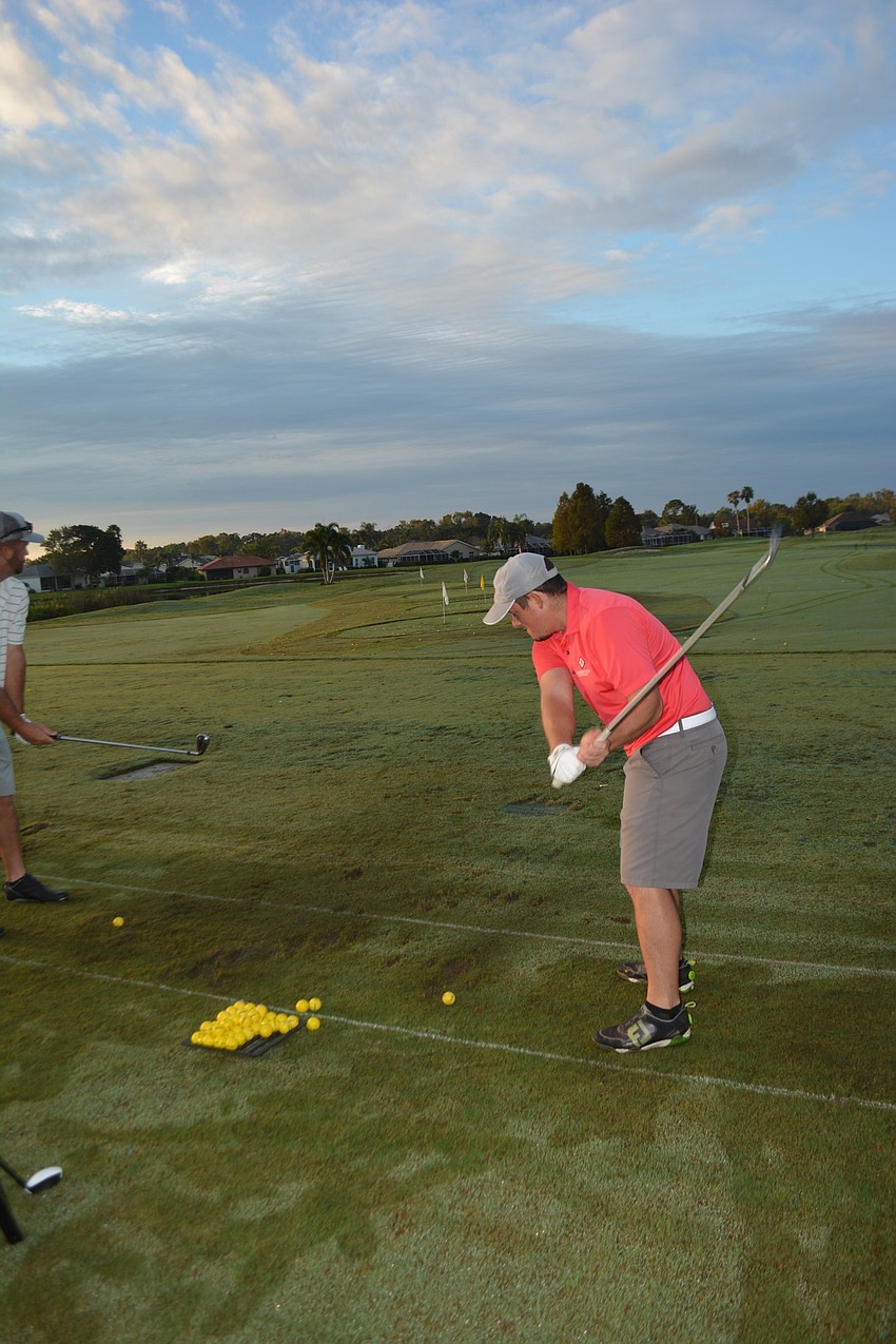 Chance Helm bombs some shots on the driving range before the tournament.