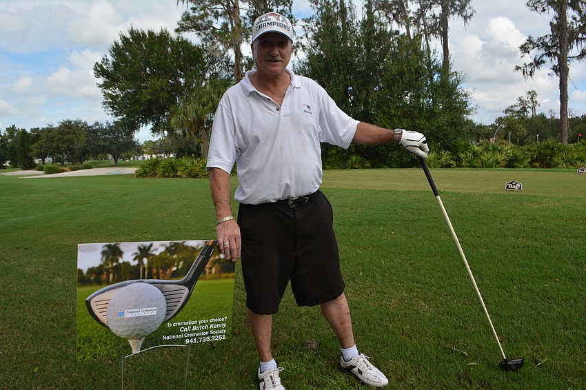 Butch Kenney gets ready to tee off on the hole his business, the National Cremation Society, sponsored.