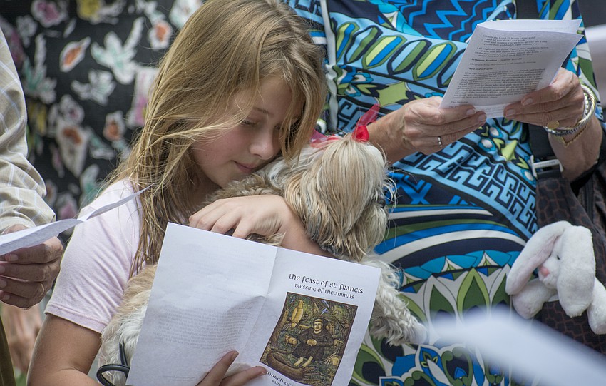 Elle Broadway dog Tia during the Church of the Redeemer's pet blessing service.