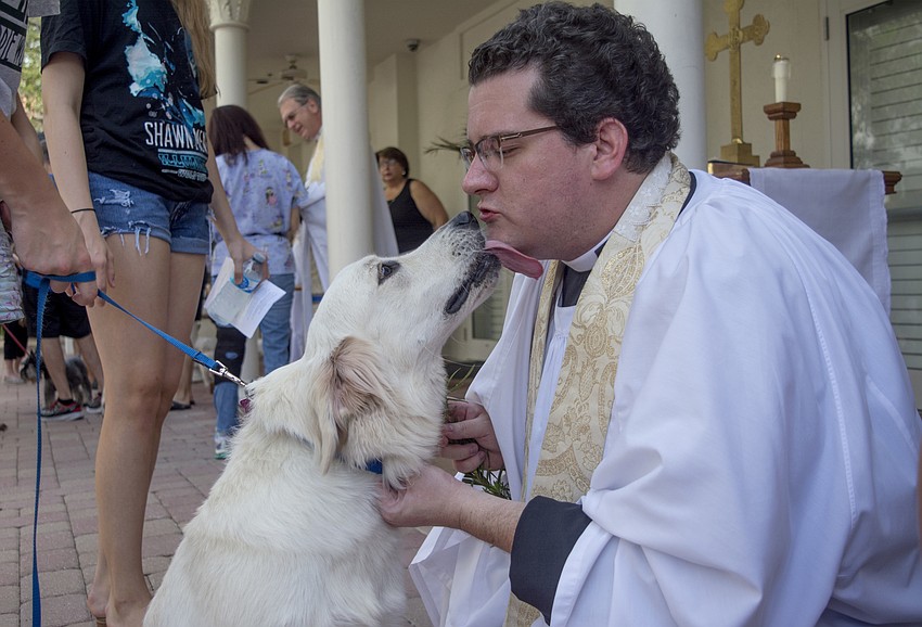 Rev. Charleston David Wilson blesses Bodi during the Church of the Redeemer's pet blessing.