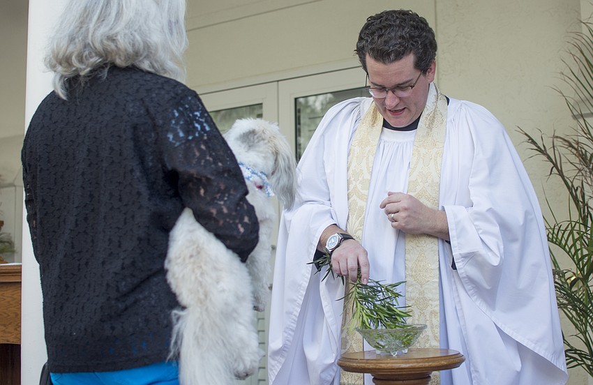 Rev. Charleston David Wilson prepares to bless parish pets.