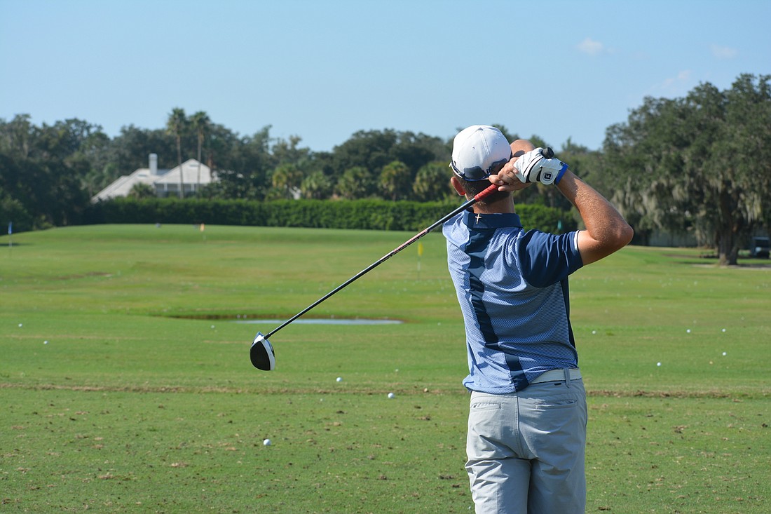 Robbie Higgins watches his drive fly toward the flag.