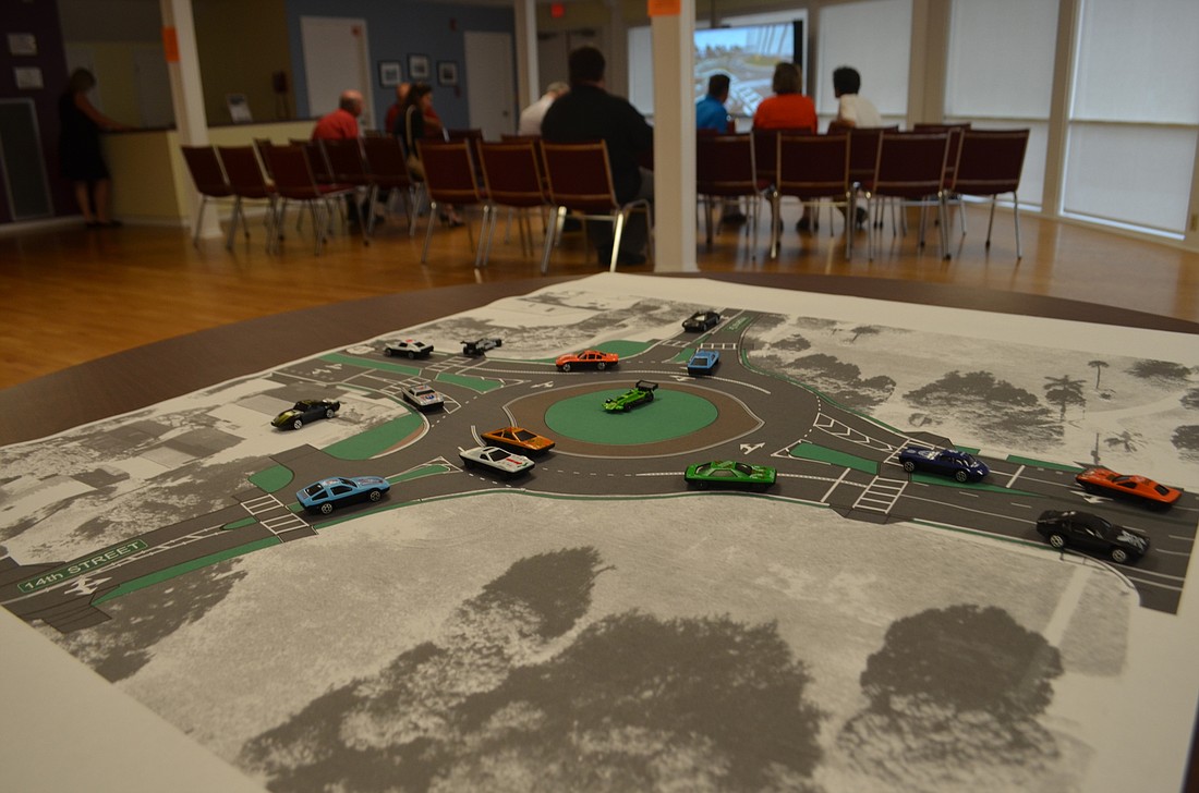 An FDOT workshop featured toy cars to provide a scaled-down model of the traffic patterns at forthcoming U.S. 41 roundabouts.
