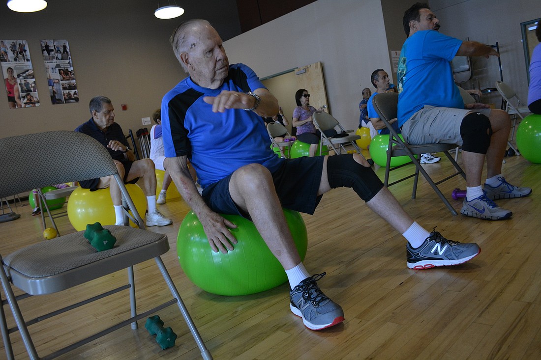 Bradenton&#39;s Dick Bernard, 86, says participating in exercises classes help him with his balance. He is pictured using a ball to practice balance during an exercise class at the Lakewood Ranch YMCA.