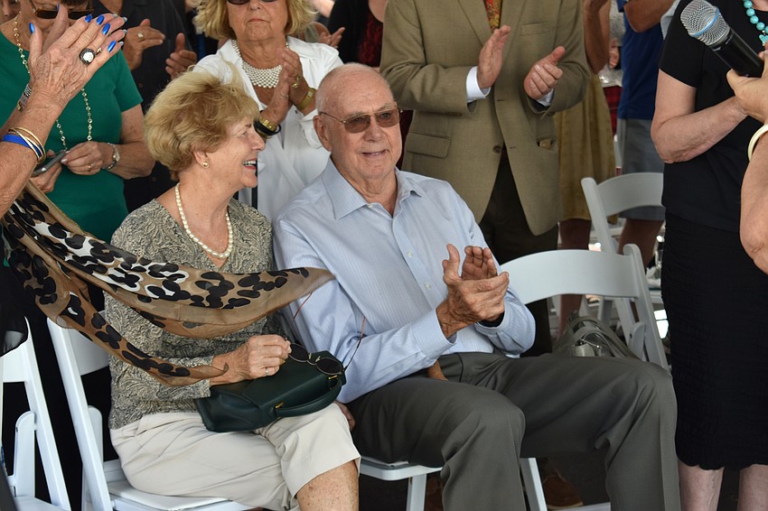 Ronda Montminy and Arnold Simonsen smile as guests give them a standing ovation.