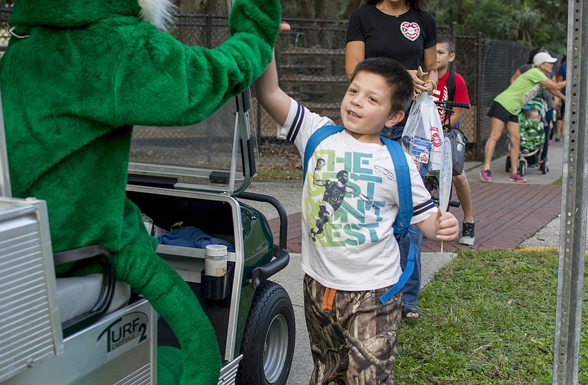 Lucas Perez high fives Wilkie the Wildcat.