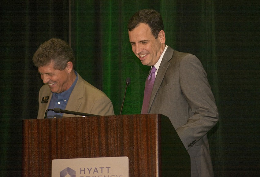 Board Chairman-elect Charlie Bailey smiles while taking the stage from Board Chairman George McGonagil.