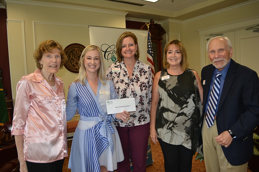 Community Fund advisor Amanda Tullidge (second from left) presents a check for $5,000 to Neuro Challenge Foundation's June Schuer, Robyn Faucy, Kathie Musto and Stan Schuer.