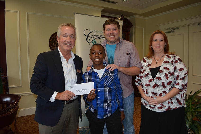 Kreg Hickman, GE’s regional manager, presents a check for $5,000 to Big Brother, Big Sisters' Zedrick, Seth Inlow and Christina Witt. The organization does not give the last names of the children it serves.