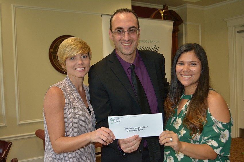 Community Fund board member Darren Haimer (center) presents a check for $1,438 to Early Learning Coalition's Kelly Gaylord and Raquel Sanchez.