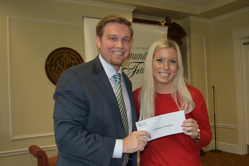 Incoming Community Fund President Garrett Shinn presents a check for $5,000 to Lydia Gartner of Foundation for Dreams.