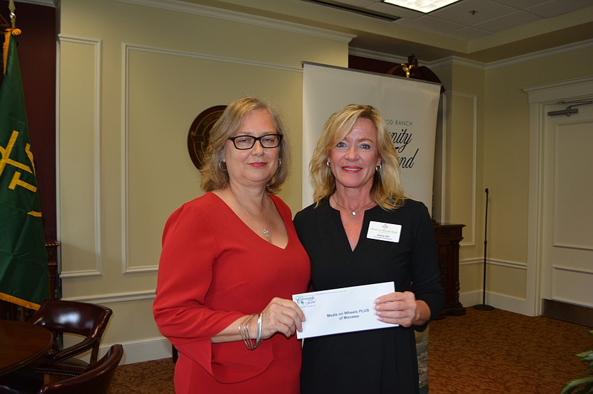 Former Community Fund advisor Julie Smith presents a check for $5,000 to Meals on Wheels' Diana Dill.