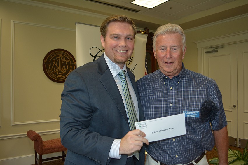 Incoming Community Foundation President Garrett Shinn presents a check for $6,500 to Stillpoint House of Prayer's Jim Keiner.