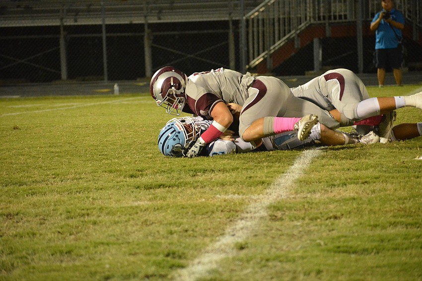 Junior linebacker Julian Lowenstein stares at a Newsome quarterback after sacking him.