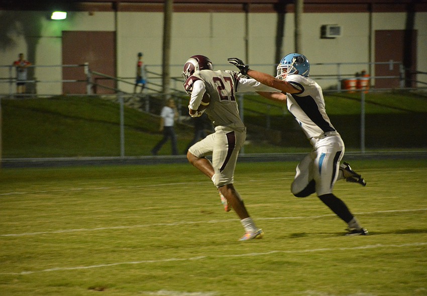 Senior Aaron Pritchett stiff arms a defender after blocking a punt and returns it for a touchdown.